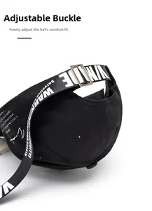 Detailed macro view of the black cotton baseball cap showing metal adjustable buckle back