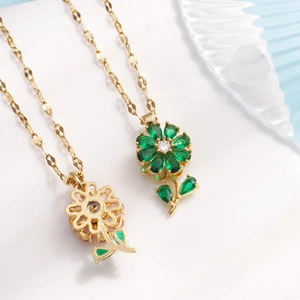 Rotating flower pendant necklaces in gold with green zircon stones on O-link chains