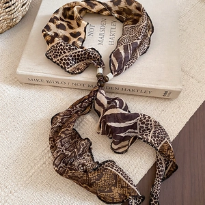 Detail of vintage leopard print chiffon scarf necklace with textured resin beads