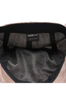 Detailed macro view of 100% cotton inner care label and black sweatband of newsboy cap