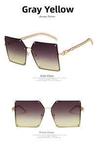 Detail view of large polygon sunglasses with gray-yellow gradient lenses and gold chain temples