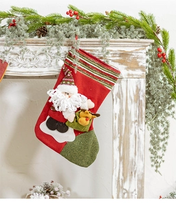 Detailed knit Christmas stocking featuring 3D Santa and reindeer on a rustic mantle