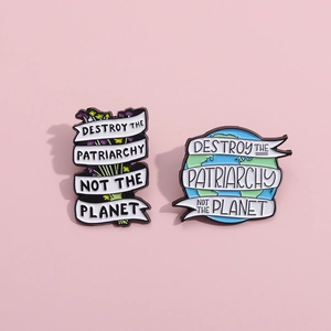 Enamel brooch set with flower and earth design and Destroy the Patriarchy slogan