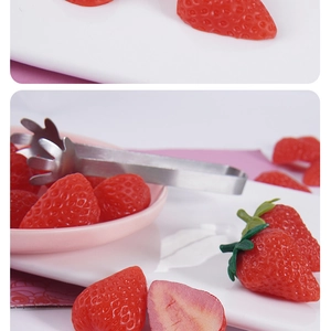 Macro shot of realistic PVC strawberry slices and whole berries for cake decor and DIY