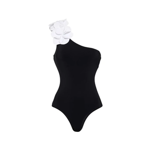 Detail of elegant one-shoulder black swimsuit featuring a large white 3D floral applique