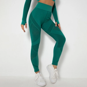 Detail of emerald green seamless yoga set showing breathable mesh texture and knitted patterns