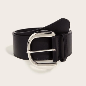 Detail of vintage wide black leather belt with silver horseshoe buckle on white background