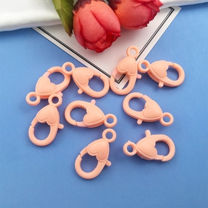 Flat lay of pink heart-shaped acrylic lobster clasps for DIY phone chains and keychains