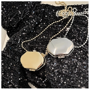 Octagonal mini metal crossbody bags in gold and silver with ball chains on sequins