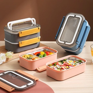 Detail view of double-layer stainless steel lunch box with divided compartments and food