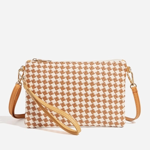 Brown and white checkered woven crossbody straw bag with leather strap and gold hardware