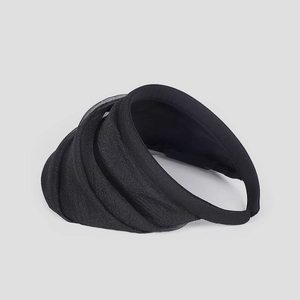 Detail of black organza ruched headband visor with multi-layer pleated fabric texture