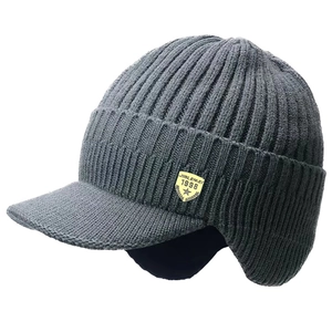 Detail of dark grey knit winter hat featuring earflaps and a thick warm lining