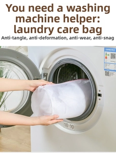 Cylindrical mesh laundry bag with pink zipper being placed in a washing machine