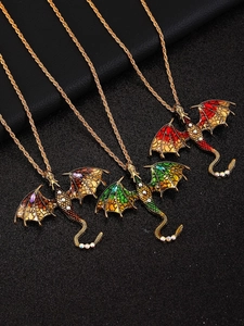 Detailed view of three hip hop style dragon pendants with vibrant enamel and rhinestones