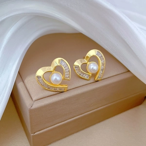 Elegant gold titanium heart earrings with cubic zirconia and white pearls on silk