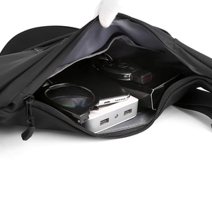 Detail view of the spacious inner compartments of a waterproof black crossbody chest bag