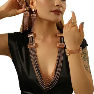 Golden multi-layer long necklace set with tassel earrings and ring on model
