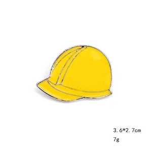 Detailed view of a yellow safety helmet enamel brooch pin measuring 3.6x2.7cm and 7g weight