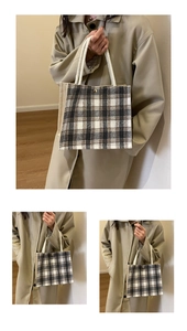 Detail of checkered canvas tote bag featuring white braided rope handles and fabric texture