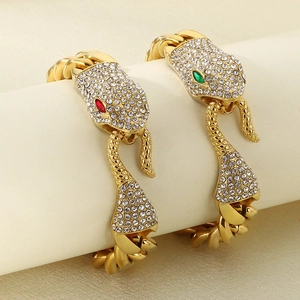 Gold-plated Cuban link bracelet featuring snake head with crystal pavé and green gem eyes
