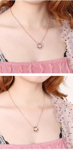 Detail of rose gold and gold smile necklaces with sparkling rhinestones on model