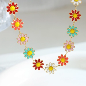 Colorful enamel daisy necklace with golden chain showing red, orange and blue floral petals