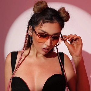 Fashionable rimless oversized sunglasses with orange gradient lenses on model