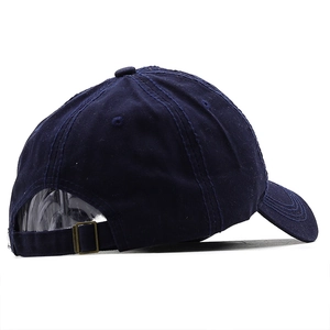 Detail of the adjustable vintage metal buckle and stitching on navy cotton baseball cap