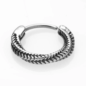 Macro shot of silver retro stainless steel hoop earring with fish scale texture