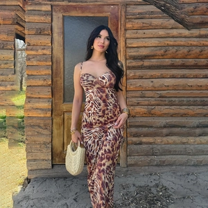 Outdoor shot of a slim leopard print slip dress with a deep V-neckline on a female model