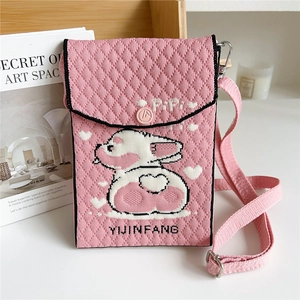 Detail of pink knitted mini crossbody bag featuring a cute 3D bunny and button closure