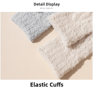 Close-up of elastic cuffs on light blue and beige coral fleece socks showing soft texture