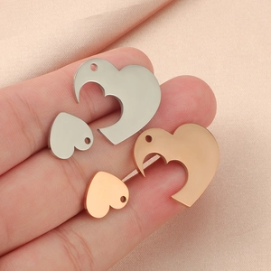 Polished stainless steel interlocking heart pendants in silver and rose gold finishes