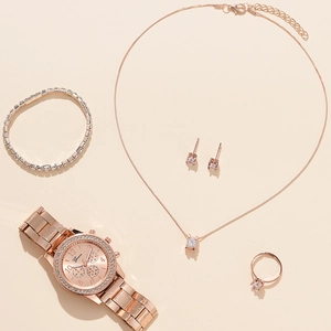 Close-up of five-piece rose gold jewelry set featuring a diamond-encrusted quartz watch