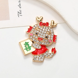 Detailed view of a festive red dragon brooch with crystals and a Chinese Xi character