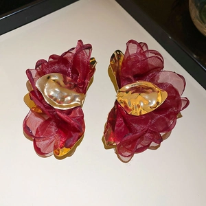 Detail of burgundy chiffon flower earrings with textured golden metallic center accent