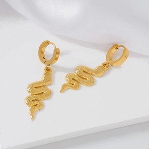 Exquisite 18K gold plated stainless steel snake hoop earrings on white silk fabric