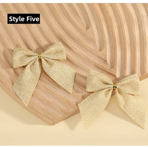 Detail of burlap plaid Christmas bows with golden metallic ties for festive decoration