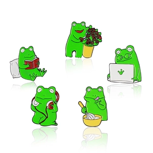 Set of 5 green frog enamel pins showing reading, gardening, working, and cooking tasks