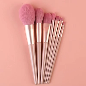 Detail of 7-piece makeup brush set with pink synthetic bristles and rose gold handles