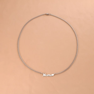 Silver stainless steel Mama necklace with heart pendant on pink background