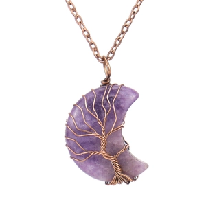 Macro shot of copper wire-wrapped amethyst moon pendant with tree of life detail