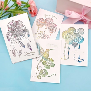 Detail of four 3D pop-up greeting cards featuring hummingbird and floral laser-cut designs