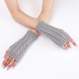 Detailed close-up of grey cable-knit arm warmers showing texture and fingerless design