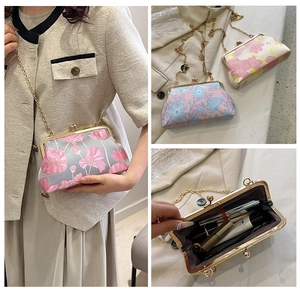 Detailed view of vintage jacquard handbag showing floral embroidery and metal chain strap