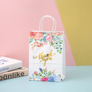 White kraft paper gift bag with floral patterns and gold foil Thank You lettering