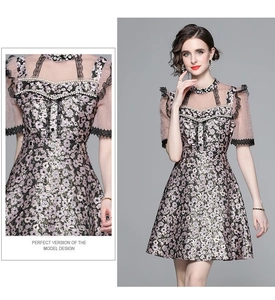 Close-up of pink floral jacquard fabric with beaded buttons and delicate lace details