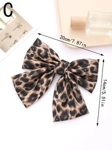 Macro detail of the leopard print satin bow hair clip showing fabric texture and 20cm size