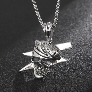 Detail shot of vintage skull and lightning pendant on box chain for men's fashion